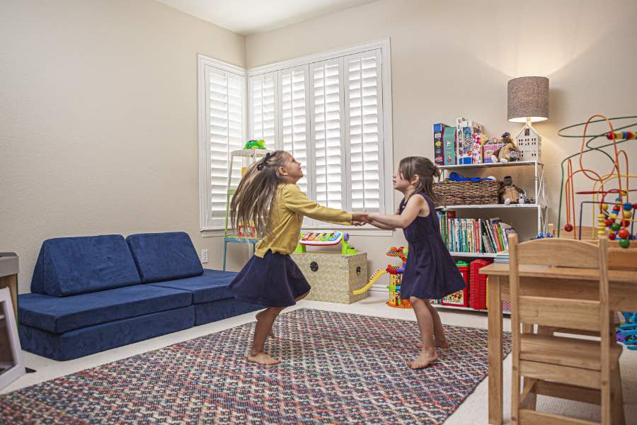 Choose Polywood shutters for durable, kid-friendly great room window treatments in Fort Lauderdale. Polywood shutters on multiple windows in a sitting area