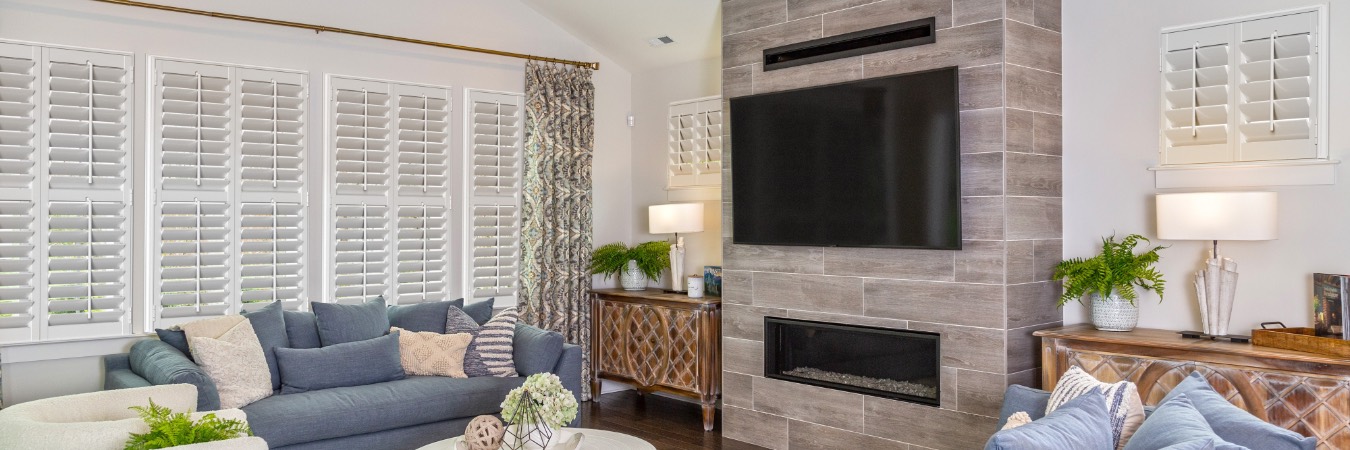 Interior shutters in Virginia Key family room with fireplace