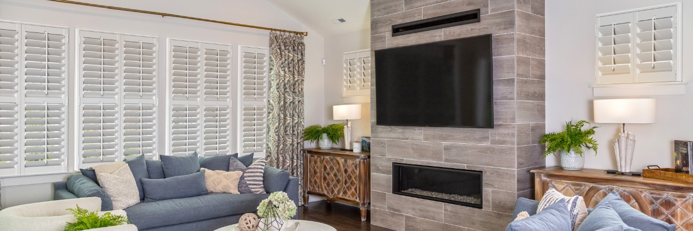 Interior shutters in a Virginia Key family room with fireplace