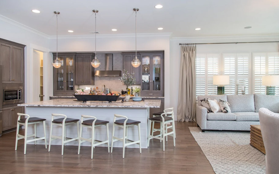 Illuminate your home with custom interior shutters in Fort Lauderdale. White arched shutters in a white kitchen with lots of light.