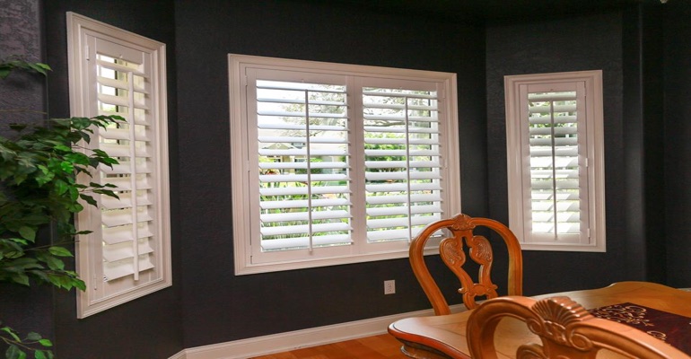 White Plantation Shutters In Dark Green Dining Room