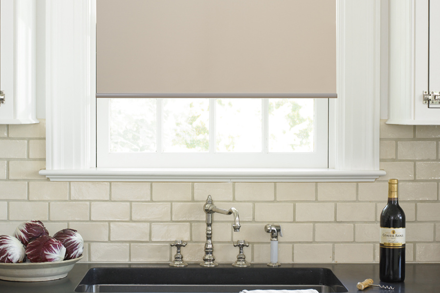 Roller shade above a kitchen sink.