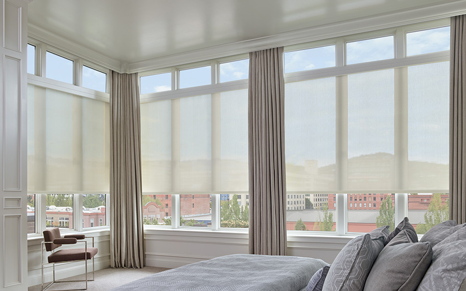 Fabric window shades come in many styles to achieve the look you want. White sheer shades in a bedroom.