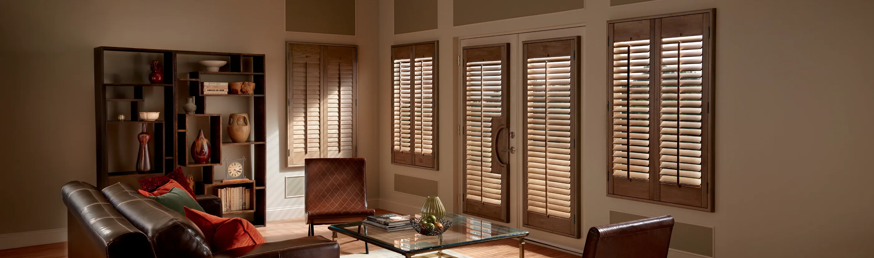 Brown Ovation shutters in a large dark living room with beige decor