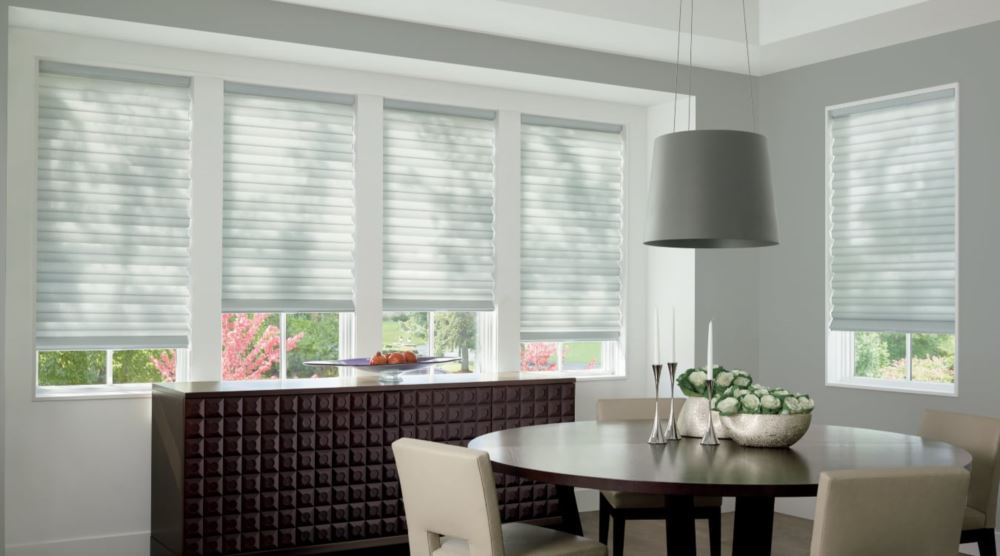 Custom cordless roller shades have a clean look and are appropriate for any room. Cordless motorized shades in a Fort Lauderdale dining room
