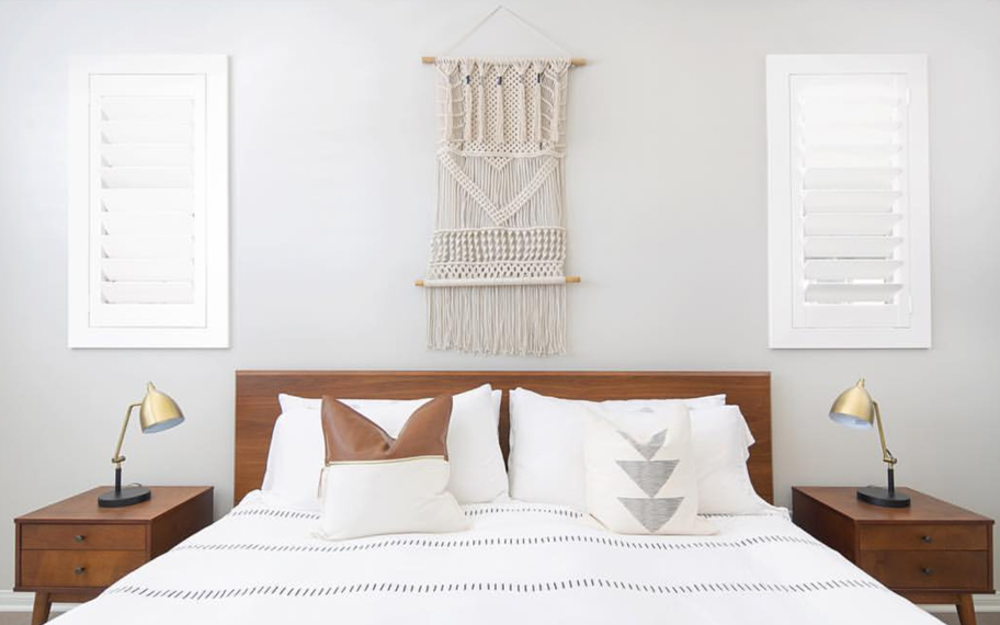 Custom-fitted louvered shutters provide excellent nighttime privacy in Fort Lauderdale. Photo Credit: Audrey Crisp Louvered shutters in a bedroom.