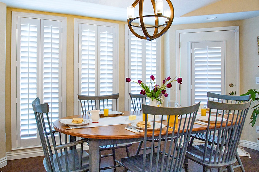 White Polywood shutters on doors and windows in a kitchen eating nook