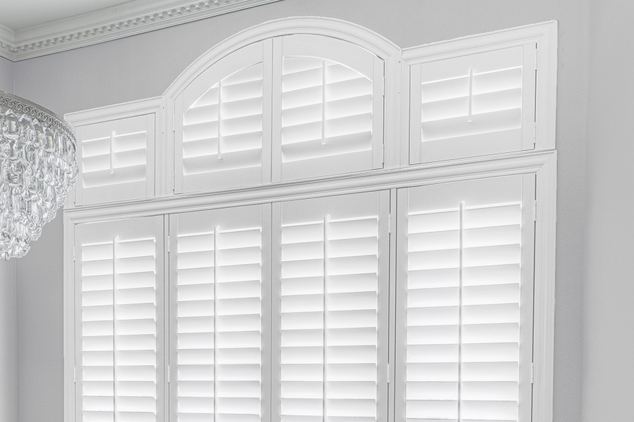 Customize your Palladian windows with white Polywood shutters in Fort Lauderdale. White Polywood Palladian windows in a dining room.