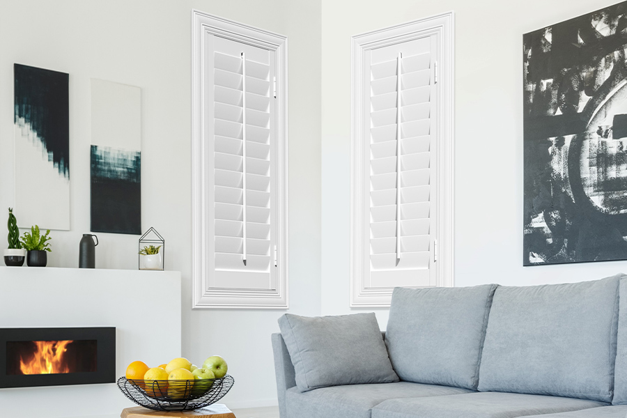 White Polywood shutters add character and class in Fort Lauderdale. White polywood shutters in a corner of a modern living room.