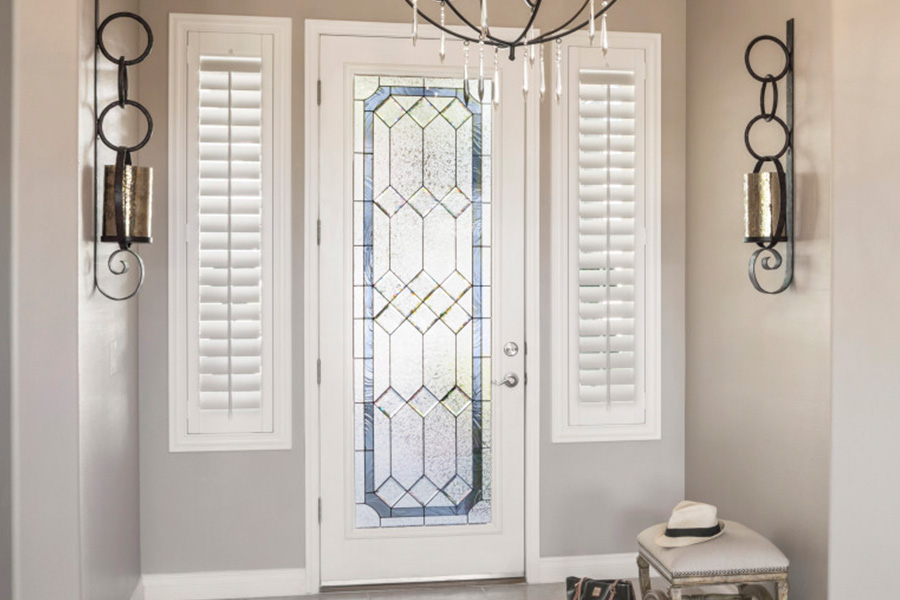 Polywood shutters offer flexibility on the brightness of natural light in Fort Lauderdale. Sidelight windows with white polywood shutters in a foyer.